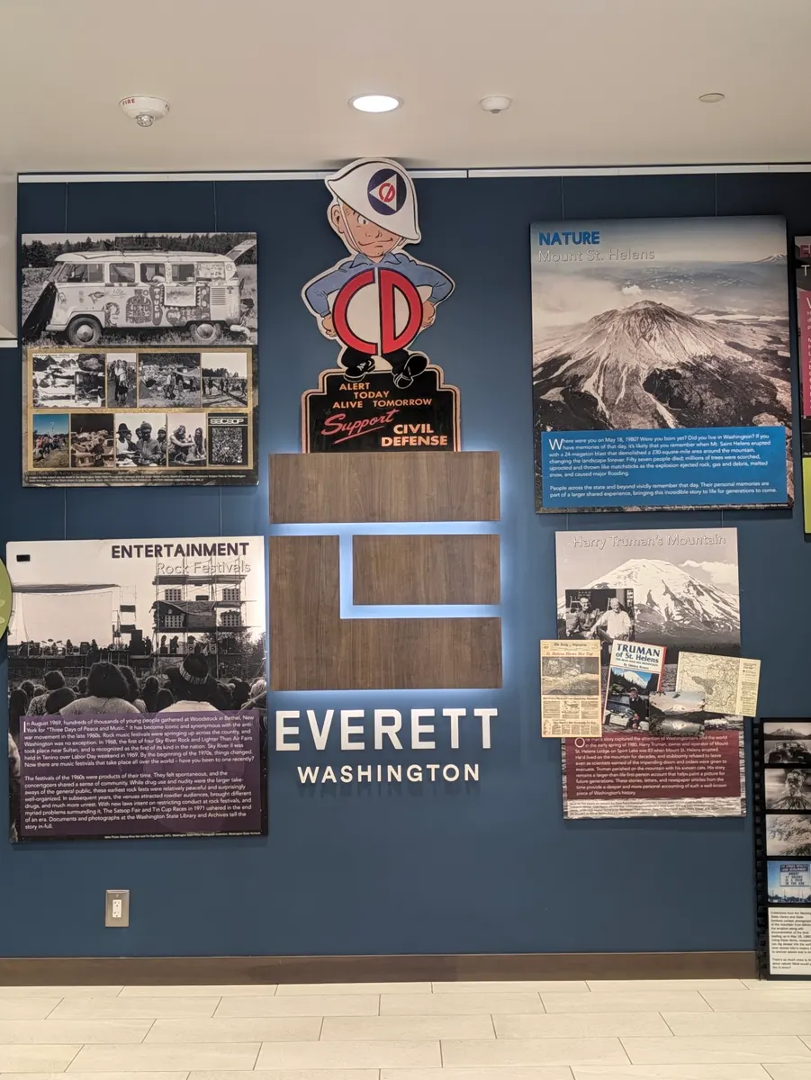 A local history display board headed Everett, Washington, with archive photographs and a Mount Rainier panel.
