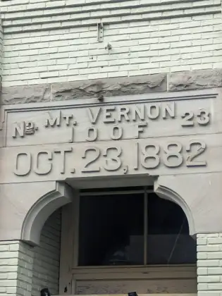 Lettering carved into the pale stone front of an old building, reading Mt. Vernon 23 I.O.O.F., October 23, 1882.