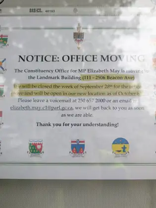 A notice in a window from the constituency office of MP Elizabeth May, announcing that the office is moving.
