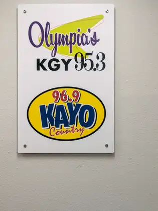 Olympia’s KGY 95.3 and 96.9 KAYO Country signs on a wall at the radio station.