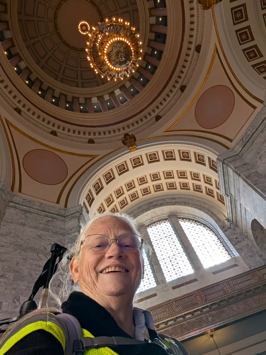 Jeana smiles beneath the patterned dome inside the Washington State Capitol.
